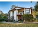 Condo building with balconies and stairs leading to entrance at 3455 Countryside Blvd # 52, Clearwater, FL 33761