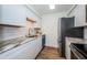 Charming galley kitchen with white cabinets and granite countertops at 3455 Countryside Blvd # 52, Clearwater, FL 33761