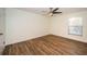 Well lit bedroom with wood-look flooring and ceiling fan at 3455 Countryside Blvd # 52, Clearwater, FL 33761