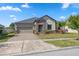 One-story home with stone accents and a two-car garage at 8025 Roma Dune Dr, Wesley Chapel, FL 33545