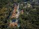 Aerial view of townhome community with mature trees and a community pool, nestled among natural surroundings at 4399 Brooker Creek Dr, Palm Harbor, FL 34685