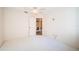 Cozy bedroom with a ceiling fan, white carpet and a laundry area, offering a comfortable and convenient space at 4399 Brooker Creek Dr, Palm Harbor, FL 34685