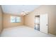 Bright bedroom with carpet, a ceiling fan, and a window providing ample natural light at 4399 Brooker Creek Dr, Palm Harbor, FL 34685