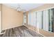 Bright bedroom with wood flooring, natural light, and a ceiling fan, creating a serene retreat for relaxation at 4399 Brooker Creek Dr, Palm Harbor, FL 34685