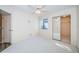 Bright bedroom with neutral carpet, a ceiling fan, and closet with mirrored doors at 4399 Brooker Creek Dr, Palm Harbor, FL 34685