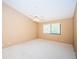 Comfortable bedroom with ceiling fan and a window bringing in natural light at 4399 Brooker Creek Dr, Palm Harbor, FL 34685
