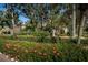 Community sign in a lush garden setting with a well maintained sign and plants at 4399 Brooker Creek Dr, Palm Harbor, FL 34685