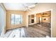 Bright living room with wood flooring, ceiling fan, and fireplace, offering a cozy space for relaxation and entertaining at 4399 Brooker Creek Dr, Palm Harbor, FL 34685
