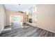 Bright living room with wood floors, ceiling fan, and fireplace, offering a cozy space for relaxation and entertaining at 4399 Brooker Creek Dr, Palm Harbor, FL 34685