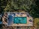 Aerial shot of a private in-ground pool with brick paver patio and white fence, perfect for relaxation and outdoor enjoyment at 4399 Brooker Creek Dr, Palm Harbor, FL 34685