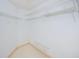 Spacious walk-in closet featuring white wire shelving for optimal storage and organization at 4399 Brooker Creek Dr, Palm Harbor, FL 34685