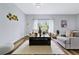 Spacious living room featuring a large window and comfortable furniture at 517 Madeira St, Port Charlotte, FL 33953