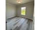 Spacious bedroom with wood-look flooring and large window at 330 Promenade Dr # 312, Dunedin, FL 34698