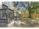 Landscaped backyard with a wooden deck and stairs at 1106 W La Salle St, Tampa, FL 33607