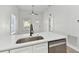 Modern kitchen island with white shaker cabinets and stainless steel sink at 1106 W La Salle St, Tampa, FL 33607