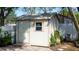 White shed with single door and window in backyard at 1214 Bolivar Ct, Dunedin, FL 34698