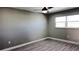 Bedroom with gray walls, wood-look floors, and a ceiling fan at 5623 80Th St N # 510, St Petersburg, FL 33709