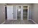 Bedroom with wood-look floors, and access to bathroom and closet at 5623 80Th St N # 510, St Petersburg, FL 33709