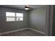 Bedroom with gray walls, wood-look floors, and a double window at 5623 80Th St N # 510, St Petersburg, FL 33709