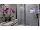 Modern bathroom with granite countertop, black fixtures, and orchid at 5623 80Th St N # 510, St Petersburg, FL 33709