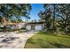 Condo exterior, two-car garage, and green lawn at 4399 Brooker Creek Dr, Palm Harbor, FL 34685