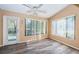 Bright Gathering room with wood-look floors and sliding glass doors at 4399 Brooker Creek Dr, Palm Harbor, FL 34685
