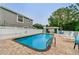 Refreshing community pool with lounge chairs and patio area at 4399 Brooker Creek Dr, Palm Harbor, FL 34685