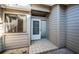 Front entrance with a white door and small tiled patio at 4399 Brooker Creek Dr, Palm Harbor, FL 34685