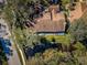 Aerial view of house with brown roof near water and road at 4399 Brooker Creek Dr, Palm Harbor, FL 34685