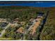 Aerial view of community near a lake with lush green trees at 4399 Brooker Creek Dr, Palm Harbor, FL 34685