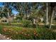 Landscaped entrance to Brooker Creek Villas and Townhomes with signage at 4399 Brooker Creek Dr, Palm Harbor, FL 34685