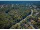 Aerial view of road and community near a wooded area at 4399 Brooker Creek Dr, Palm Harbor, FL 34685