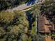 Aerial view of house near water and road, surrounded by trees at 4399 Brooker Creek Dr, Palm Harbor, FL 34685