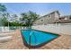 Community swimming pool with lounge chairs and patio area at 4399 Brooker Creek Dr, Palm Harbor, FL 34685