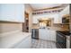 Kitchen with white cabinets, stainless steel appliances, and laundry area at 4399 Brooker Creek Dr, Palm Harbor, FL 34685