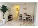 Bright dining room featuring a farmhouse style table and chandelier at 2460 Persian Dr # 6, Clearwater, FL 33763