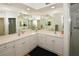 Double vanity bathroom with a large mirror and shower at 6575 99Th N Way # 22201, St Petersburg, FL 33708