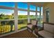 Relaxing sunroom with wicker furniture and stunning water views at 6575 99Th N Way # 22201, St Petersburg, FL 33708