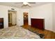 Bright bedroom with double bed, dresser, and access to a balcony at 6575 99Th N Way # 22201, St Petersburg, FL 33708