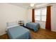 Bedroom with two twin beds, nightstand, and window at 6575 99Th N Way # 22201, St Petersburg, FL 33708