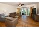 Living room featuring a sectional sofa and access to a balcony at 6575 99Th N Way # 22201, St Petersburg, FL 33708