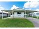 Mobile home with carport and nicely landscaped lawn at 5319 Montego Dr, Zephyrhills, FL 33541