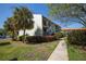 Condo building with walkway and manicured landscaping at 1515 Pinellas Bayway S # B28, Tierra Verde, FL 33715