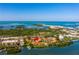 Aerial view of waterfront property with community pool and tennis courts at 1515 Pinellas Bayway S # B28, Tierra Verde, FL 33715