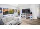 Living room with large TV, built-in shelving, and comfortable seating at 1515 Pinellas Bayway S # B28, Tierra Verde, FL 33715