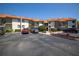 Condo building with parking area and lush landscaping at 1515 Pinellas Bayway S # B28, Tierra Verde, FL 33715