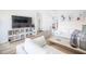 Living area with white sofa, large TV, and built-in shelving at 1515 Pinellas Bayway S # B28, Tierra Verde, FL 33715