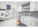 Modern kitchen with white cabinets, stainless steel appliances, and grey tile backsplash at 1515 Pinellas Bayway S # B28, Tierra Verde, FL 33715