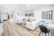 Bright living room featuring comfy sofas, a coffee table, and dining area at 1515 Pinellas Bayway S # B28, Tierra Verde, FL 33715