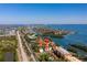 Aerial view of condo community near water, with tennis court and pool at 1515 Pinellas Bayway S # B28, Tierra Verde, FL 33715